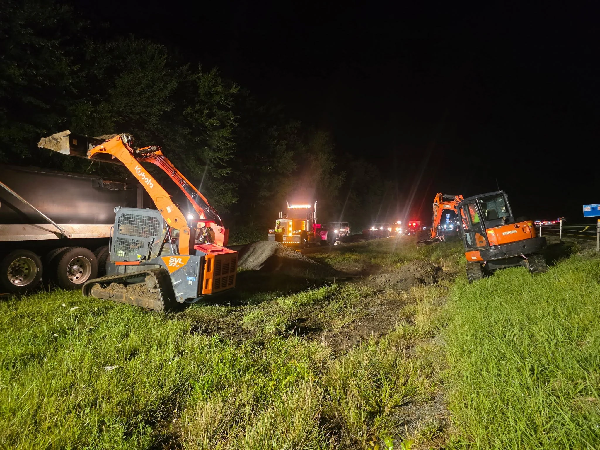 OES excavation equipment performing environmental cleanup and site remediation work at night.