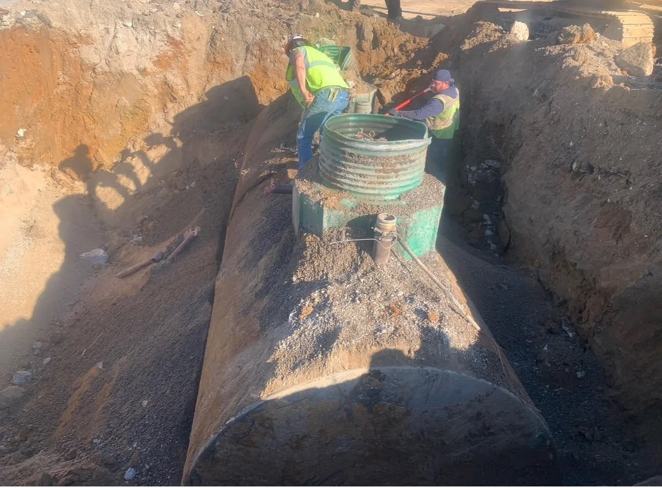 OES field crew performing environmental site work in an excavated trench.