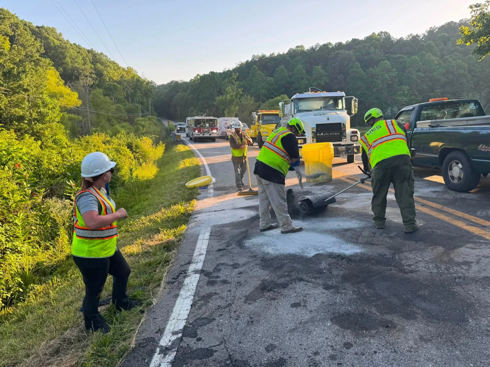 OES environmental response crew working at a roadside spill cleanup scene.