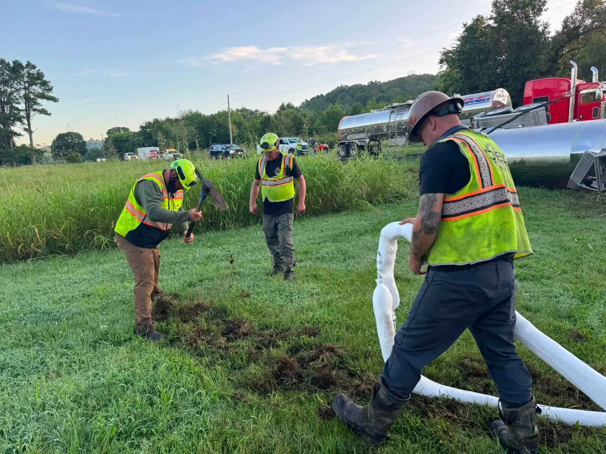 OES environmental response crew working at an overturned tanker truck incident along a roadside.