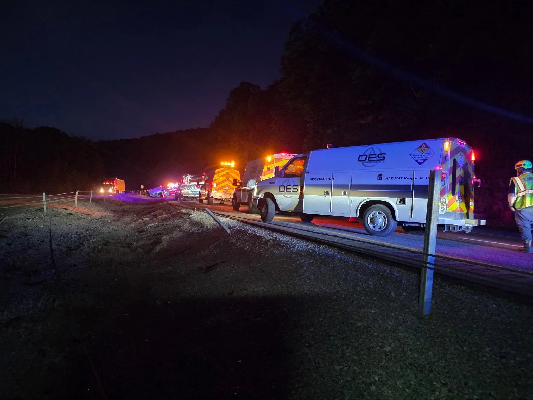 OES emergency response vehicles and field crew responding to an environmental incident at night.