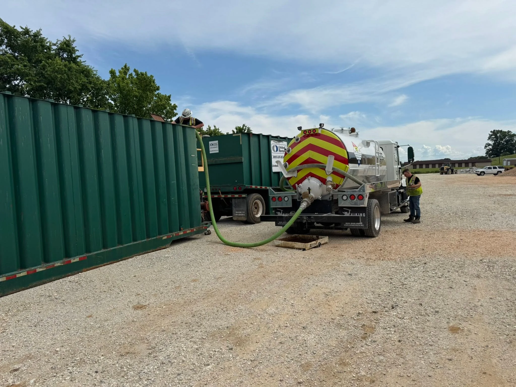 OES vacuum truck crew transferring recovered material during an environmental cleanup project.