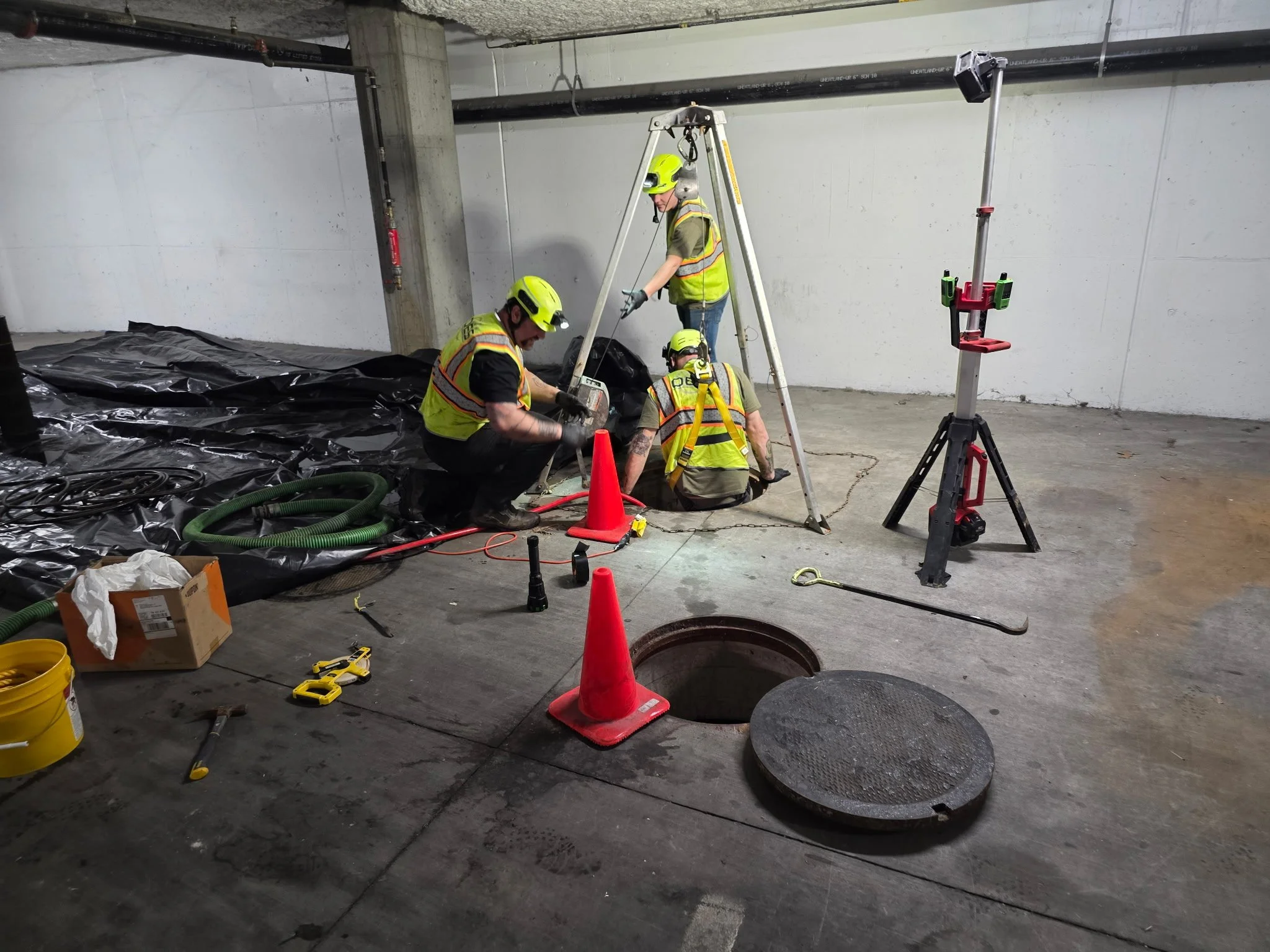 OES field crew performing specialized environmental work in an underground utility area.
