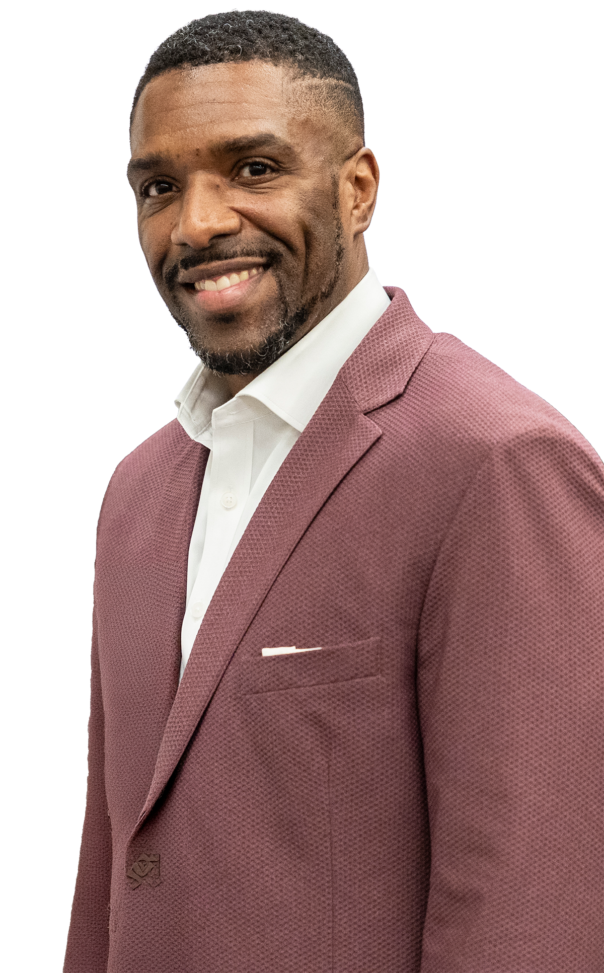 A smiling man wearing a maroon suit with a white shirt.