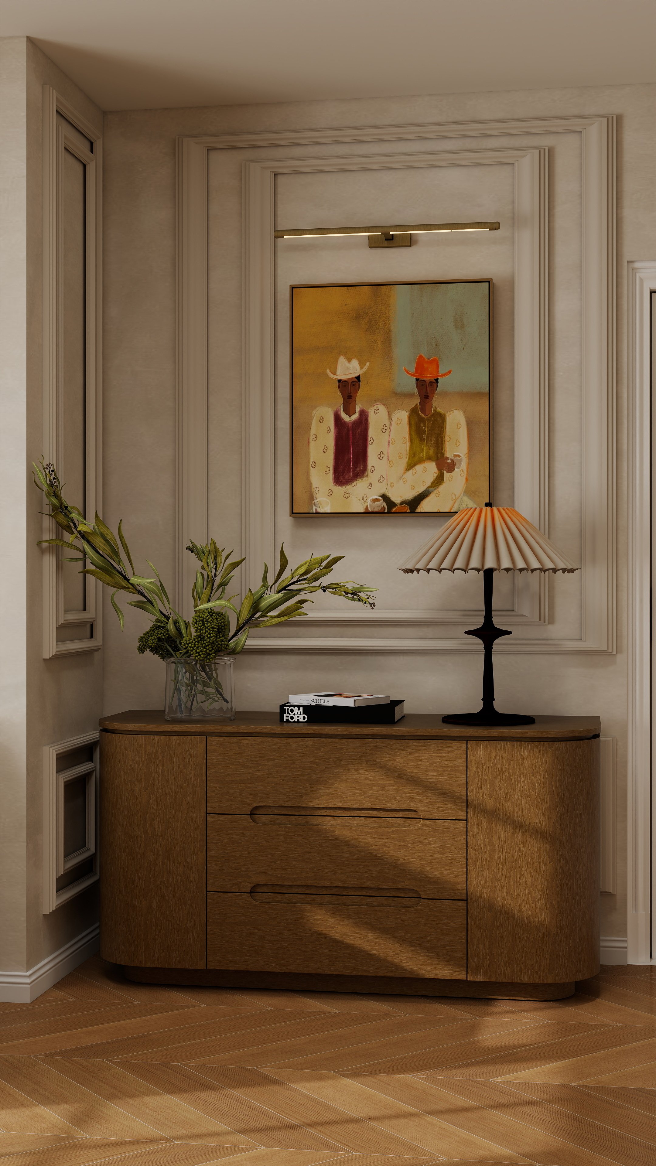 Interior wall decor with a framed colorful painting of two people wearing cowboy hats and a wooden sideboard with a vase of green plants, books, and a table lamp.