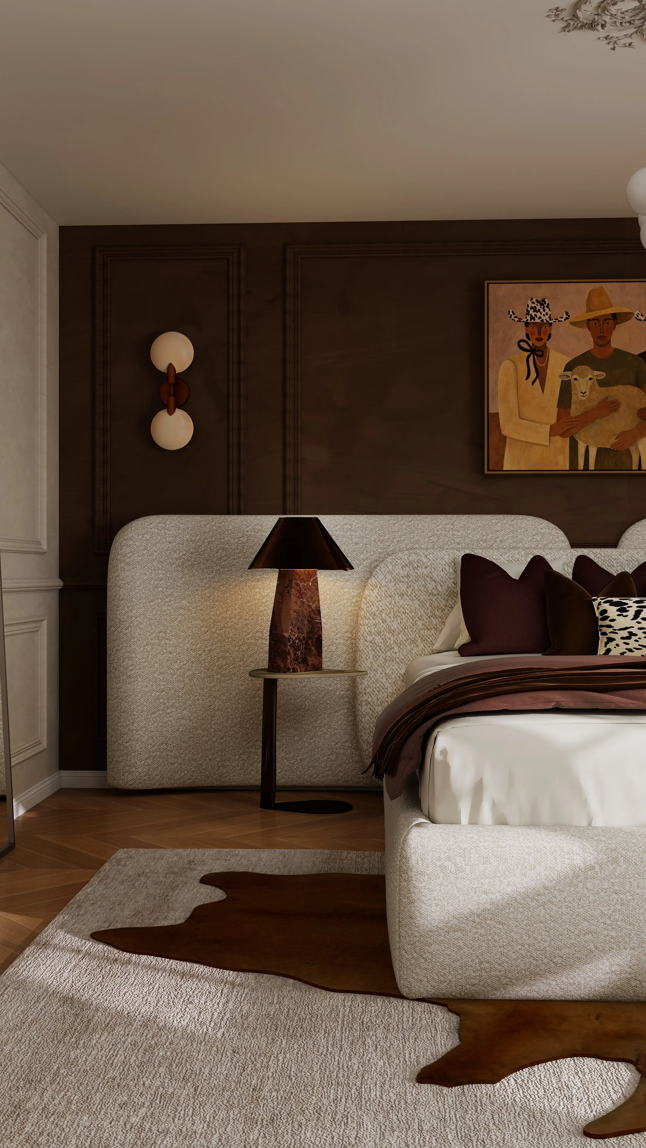 A bedroom with a cream upholstered headboard, a black and brown lamp on a round side table, a brown and black rug, and a colorful painting of two people with hats and a sheep on the wall.