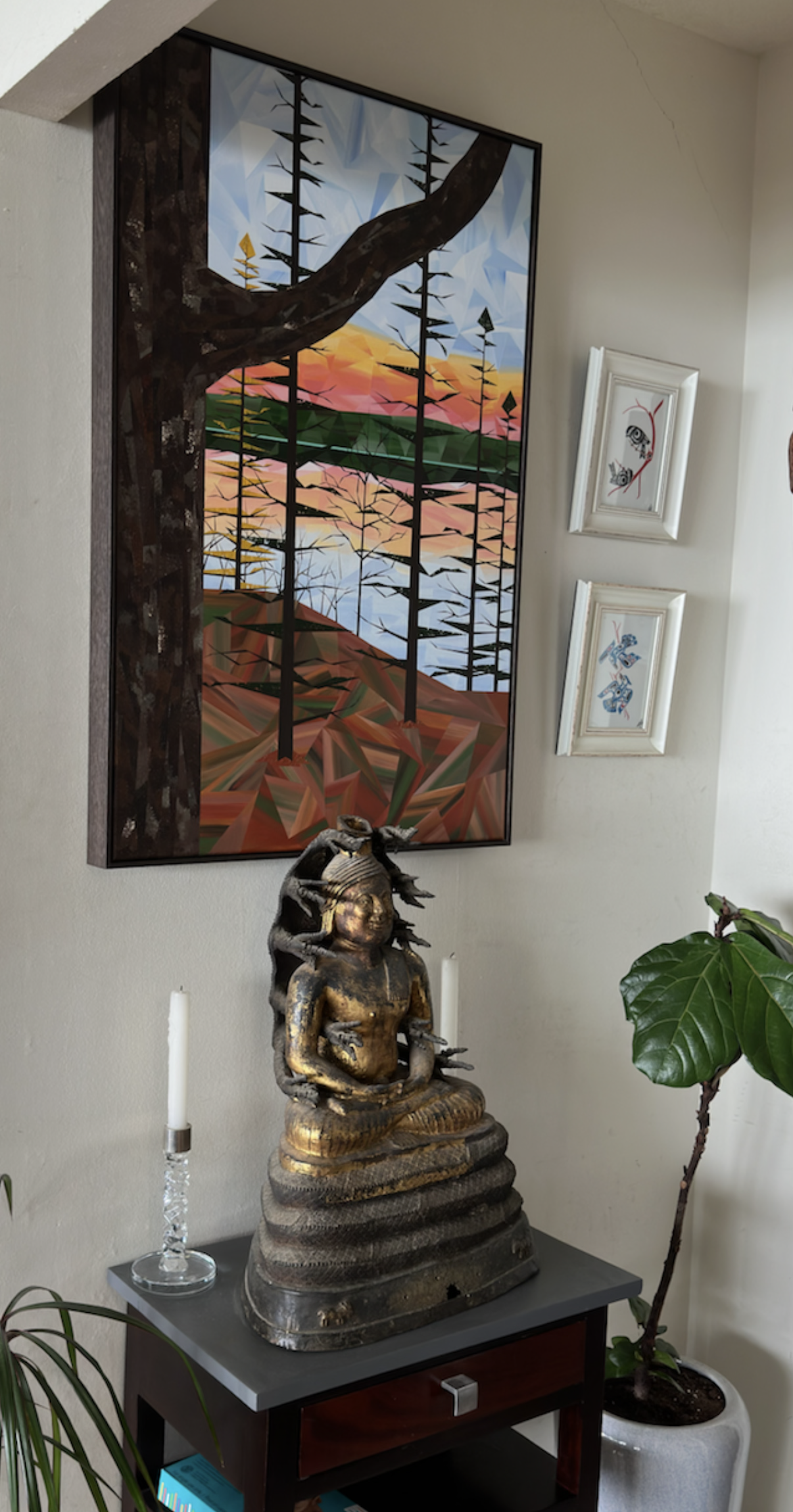 Tall geometric forest and water painting displayed in a client’s home among plants and collected objects.