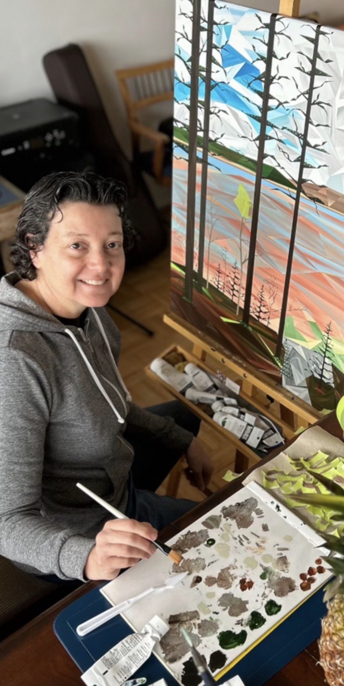 Self-taught Toronto artist Marilyn Calleja painting a geometric artwork by hand in her home, building the composition one triangle at a time.