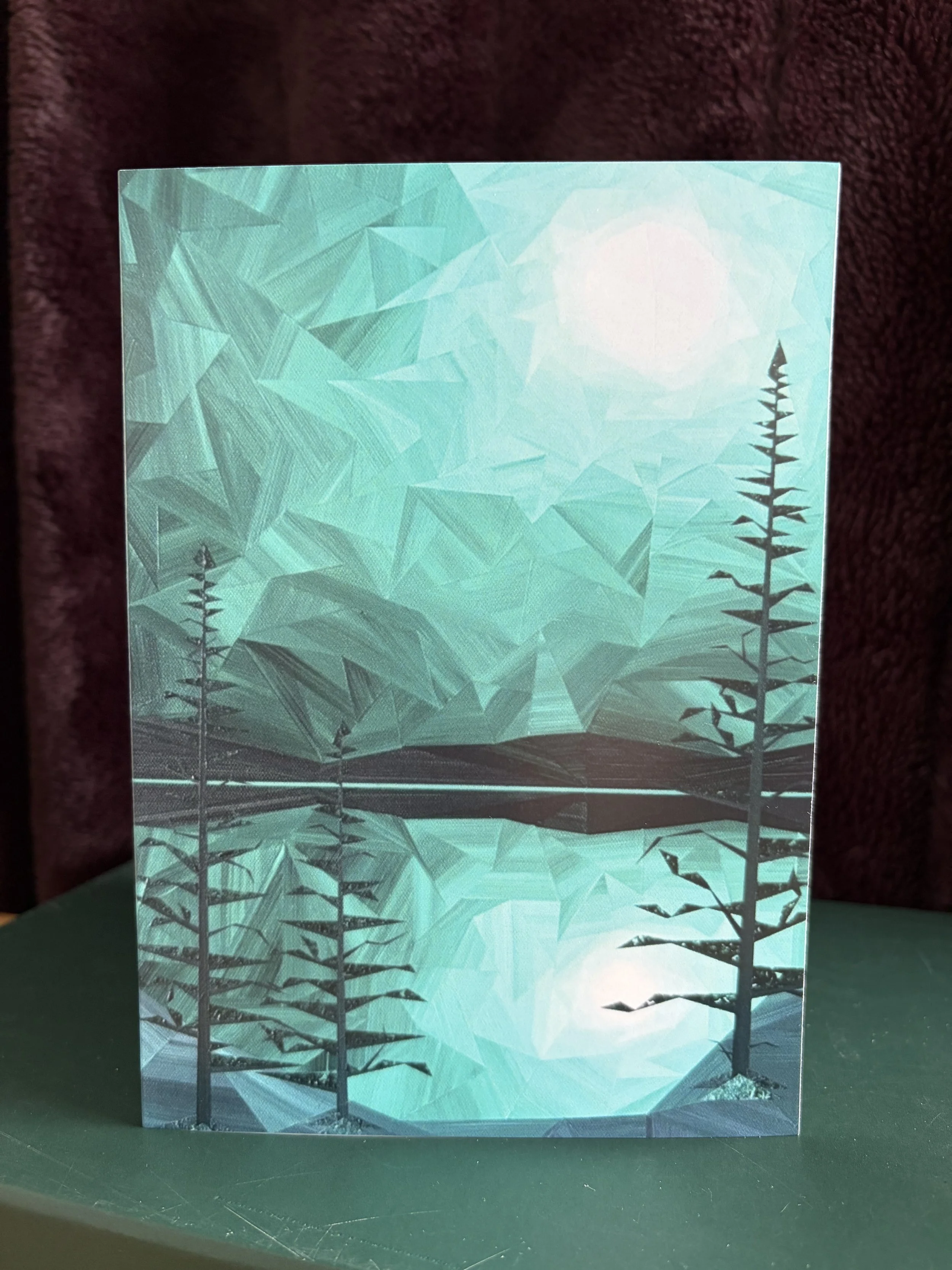 Viridian Night greeting card, featuring Marilyn Calleja’s moonlit landscape in rich green, black and white tones with reflections across the water.