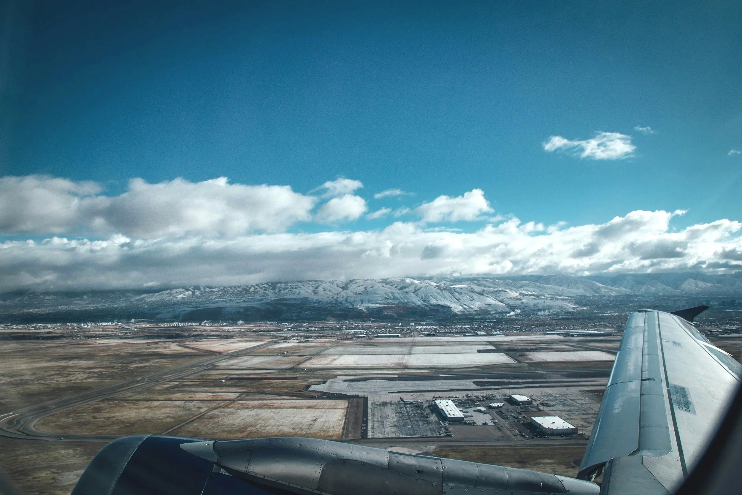 Denver International Airport and the mountains beyond are seen from the air.