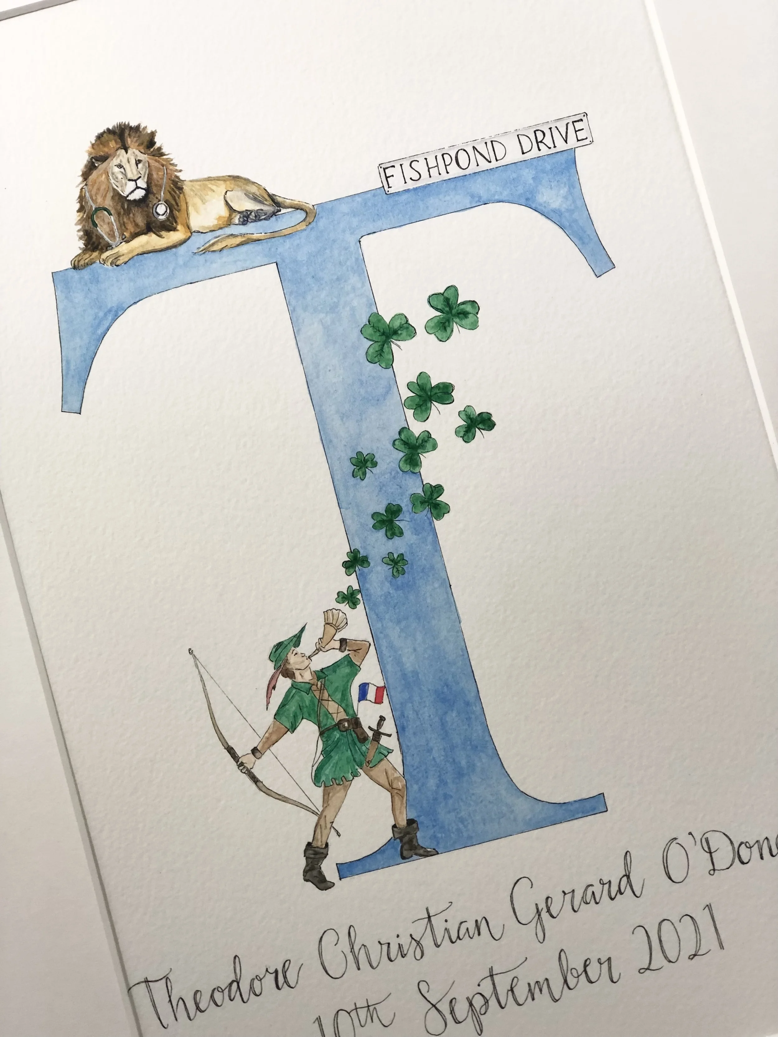 A hand-drawn illustration of a large letter 'T' filled with water and decorated with green shamrocks. A lion with a stethoscope is lying on top of the letter, and a person dressed as an explorer with a green outfit, hat, and backpack is standing at t