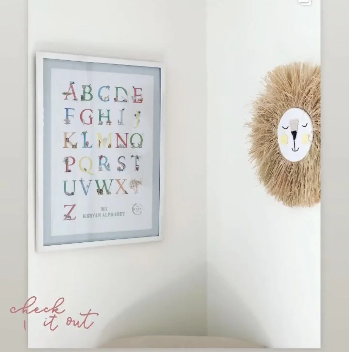 Decorative framed poster of the Kenyan alphabet with colorful letters and animal illustrations, and a plush lion face wall decoration with a fluffy mane.