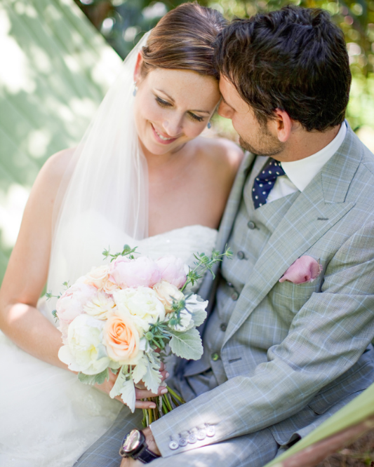 Bride and groom sharing a quiet moment with her wedding bouquet in Healdsburg, California.