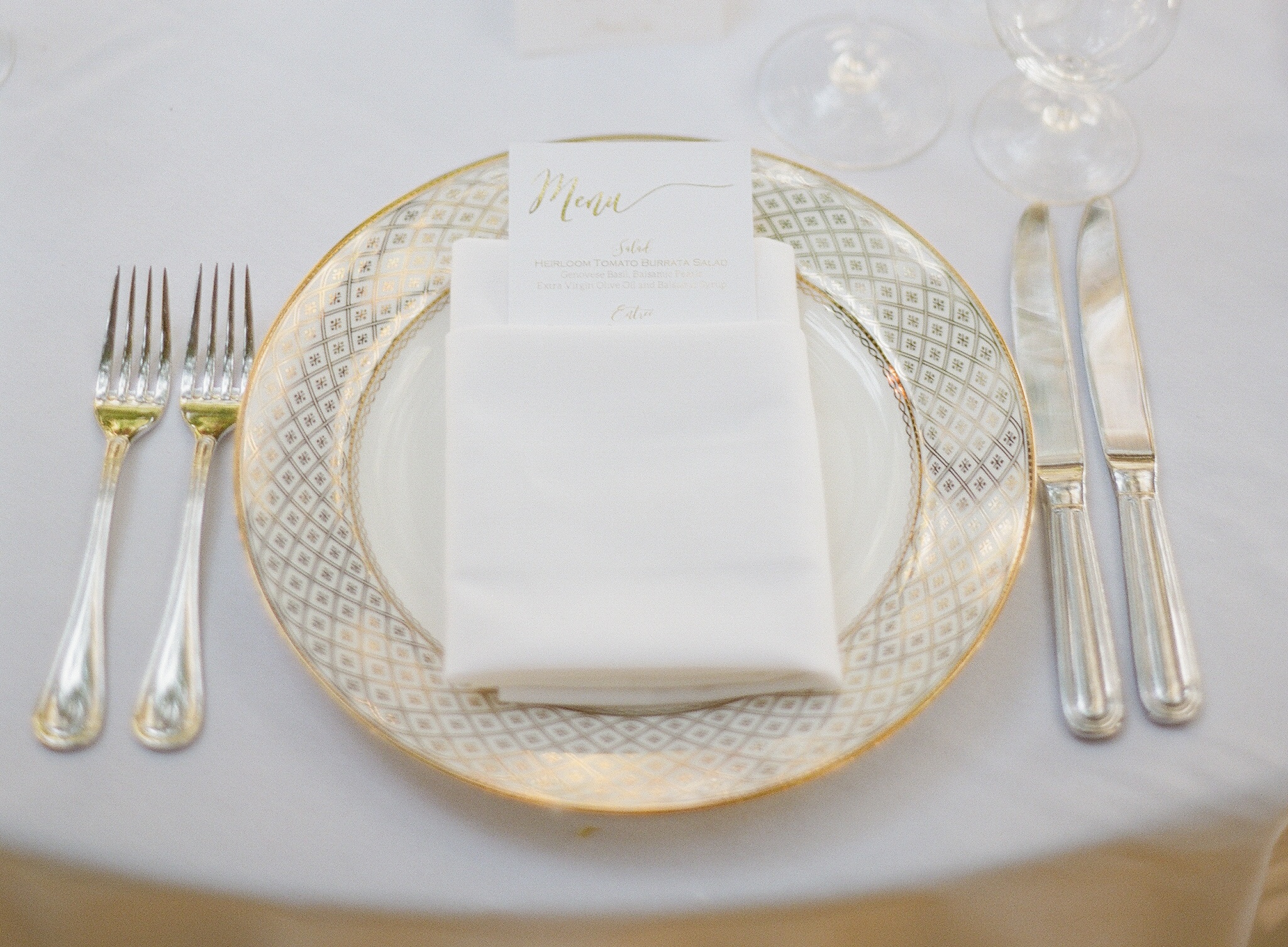 Gold-trimmed place setting at an elegant wedding reception in Sonoma, California.