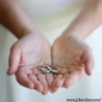 Bride holding both wedding rings in her open hands at a Kenwood, California wedding.