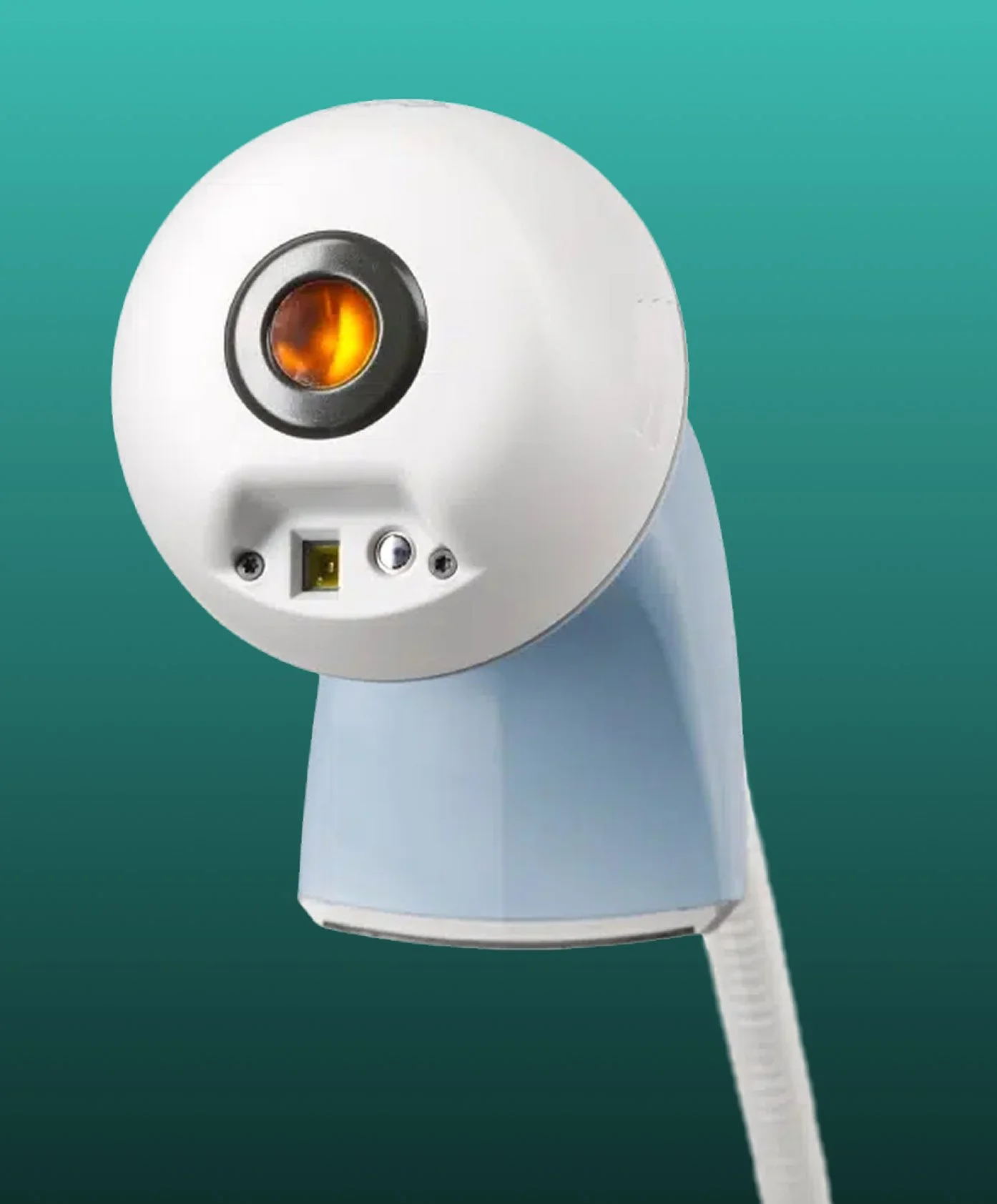 A close-up of a device with a circular black and orange nozzle and control buttons, set against a teal background.