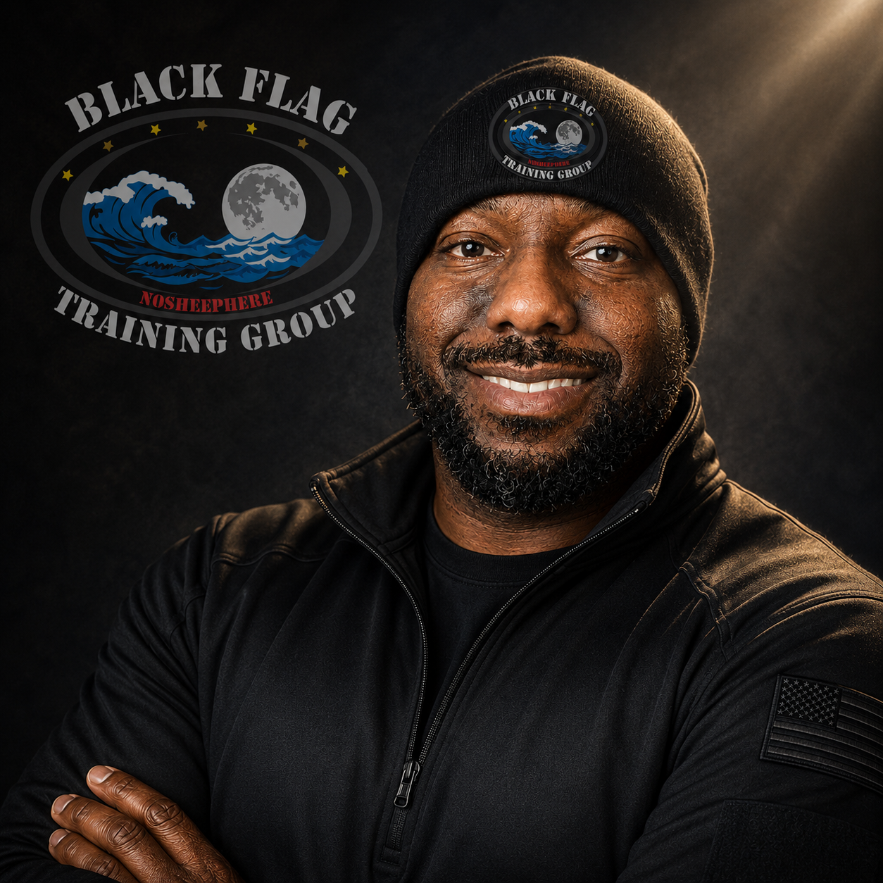 A smiling man wearing a black beanie and black jacket with a patch on the sleeve, standing in front of a dark background with a logo for Black Flag Noshephere Training Group, which features a wave, full moon, and stars.