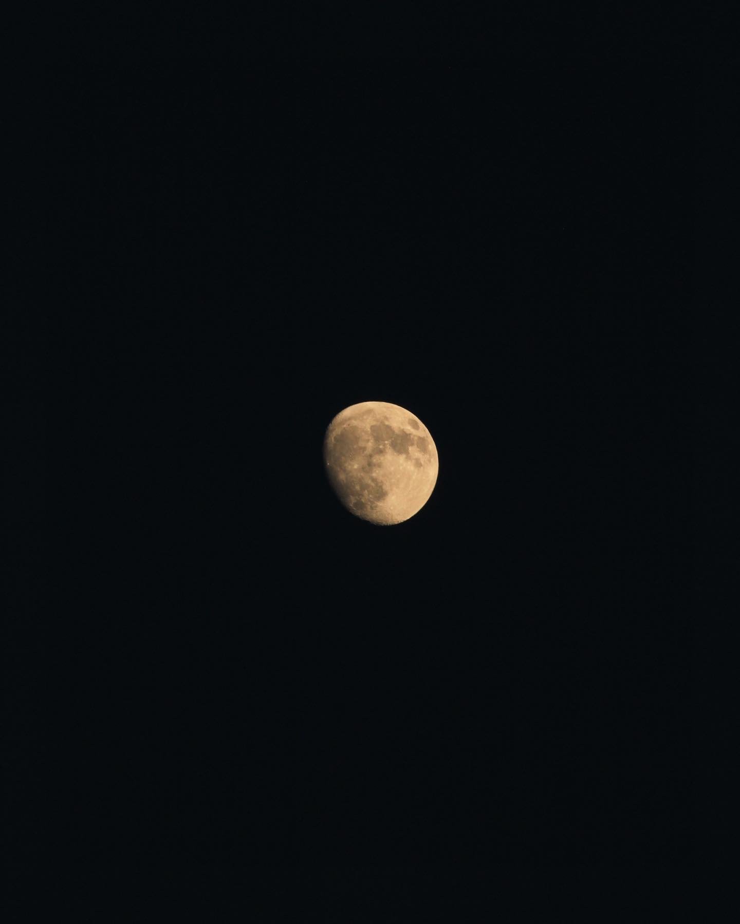 Photograph of the moon in a dark sky with no clouds.