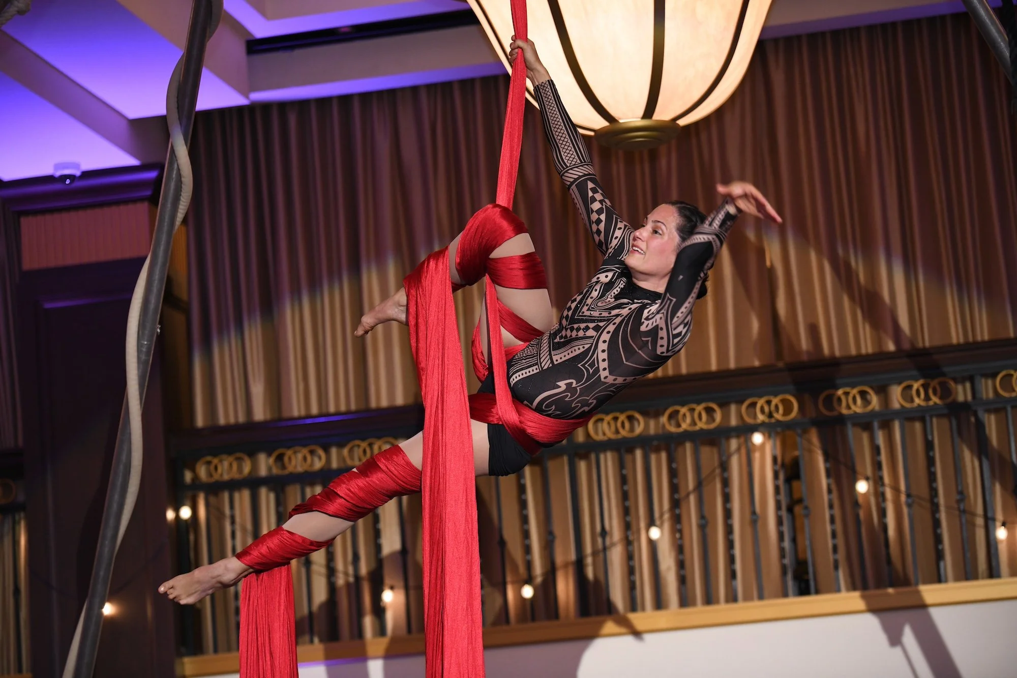 female acrobat performs aerial silk 