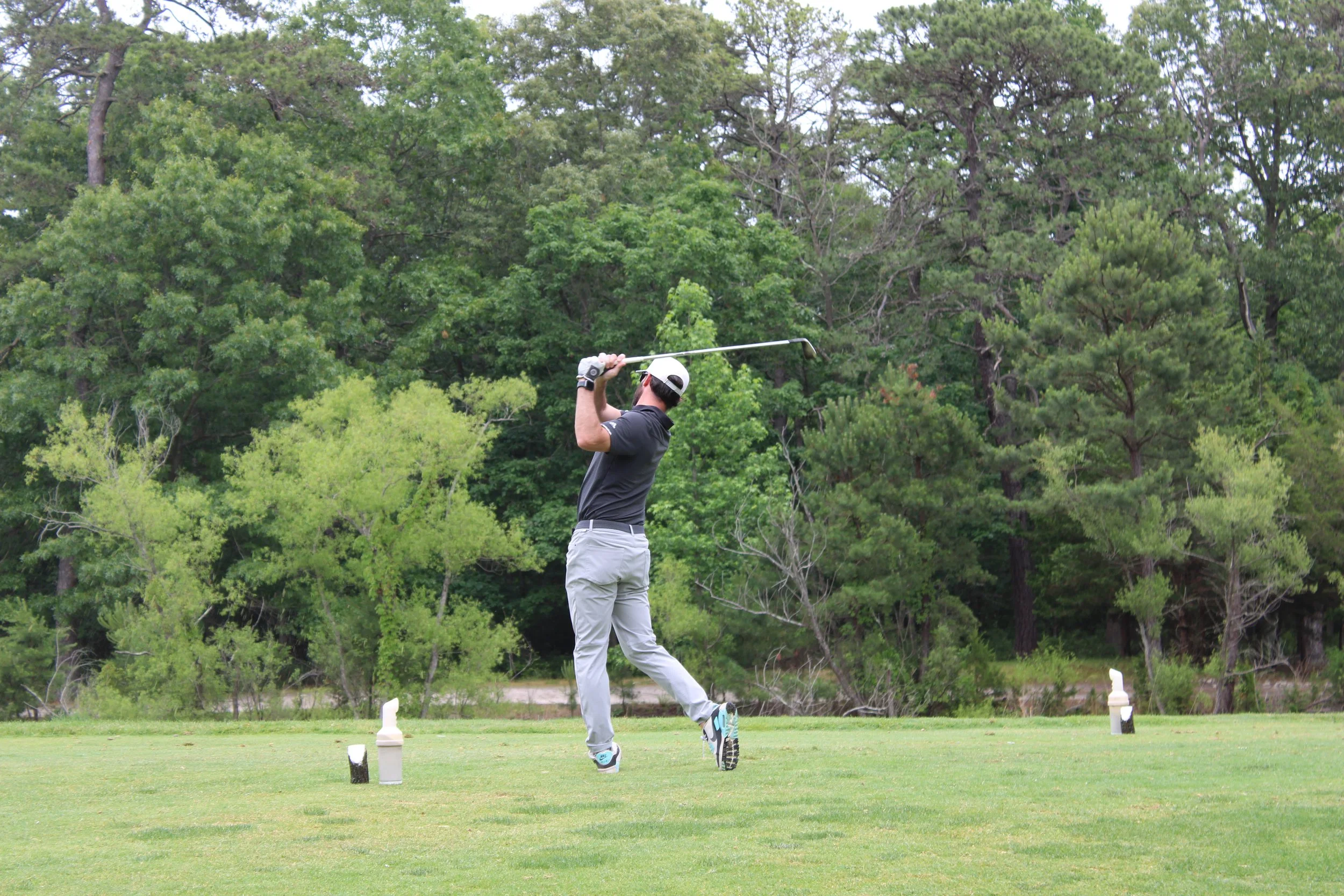 golfer swings at Acenda's annual Golf Classic