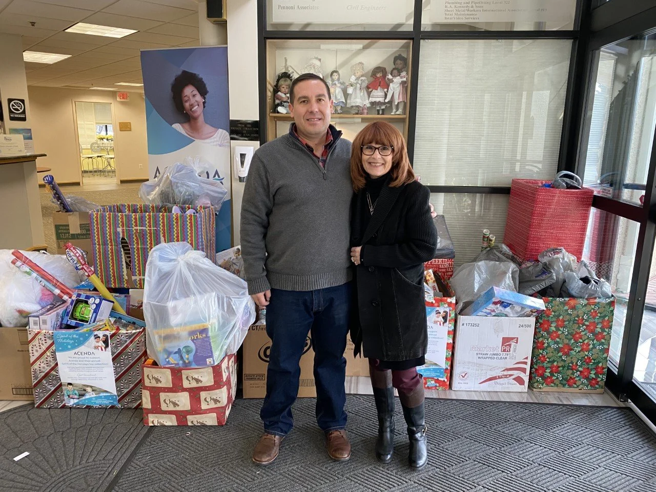 Spirit of the Holidays lead donors: Heritage Dairy posing at Acenda headquarters with toy donations