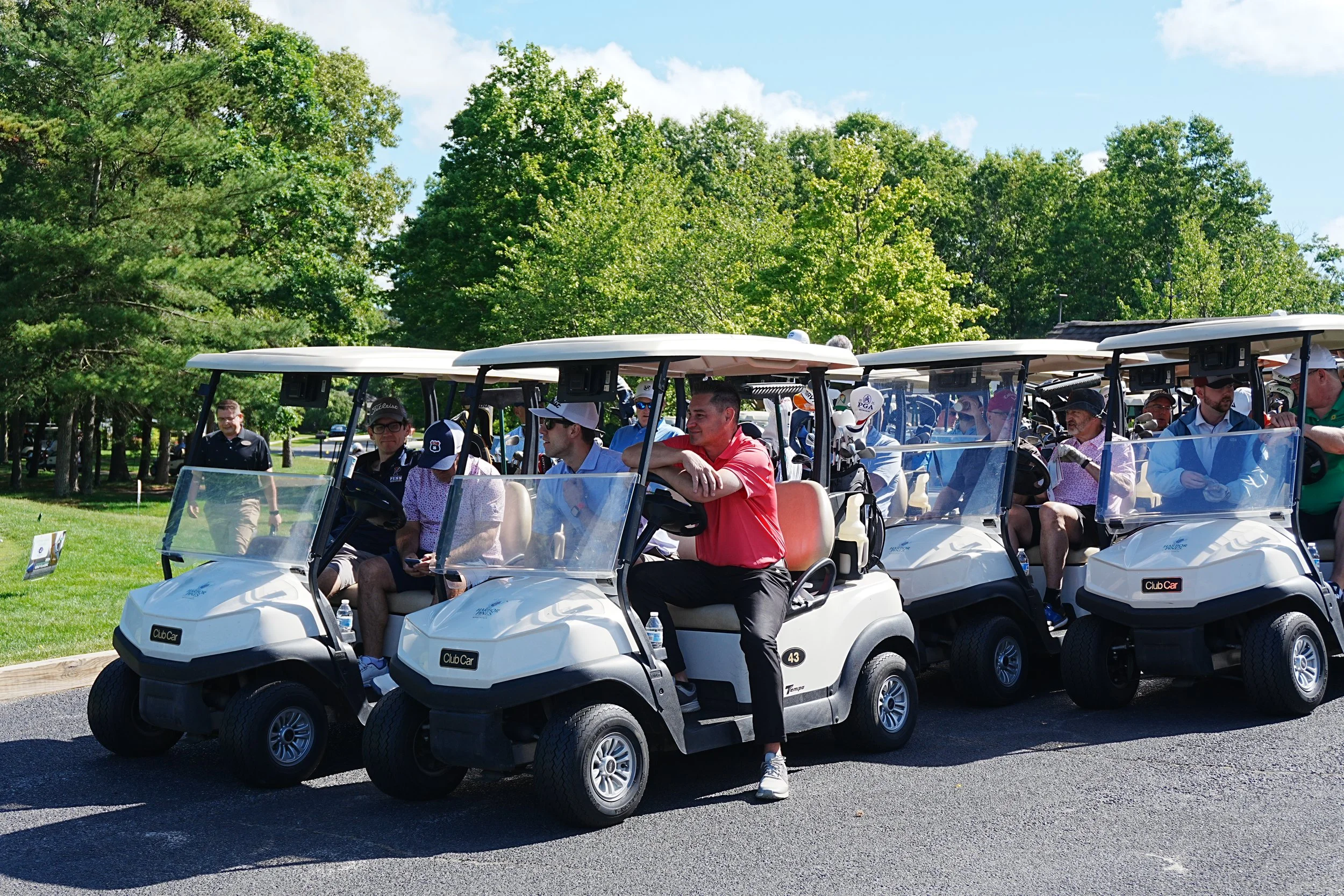 Acenda's Golf Classic - featuring golfers lining up in golf carts waiting for the official start