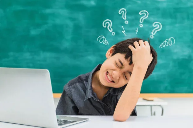 asian-confused-school-boy-using-laptop-black-board-background-with-tired-question-mark-sign_7191-1087.webp