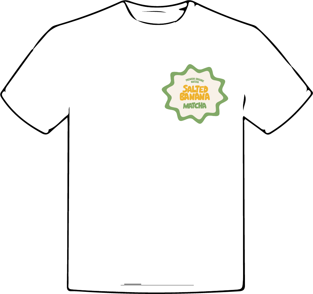 White T-shirt with a green, yellow, and orange logo on the left chest area. The logo features a green, scalloped border with the words "Premium Organic Matcha Salted Banana" in smaller green text and "Salted Banana Matcha" in larger orange and green text in the center.