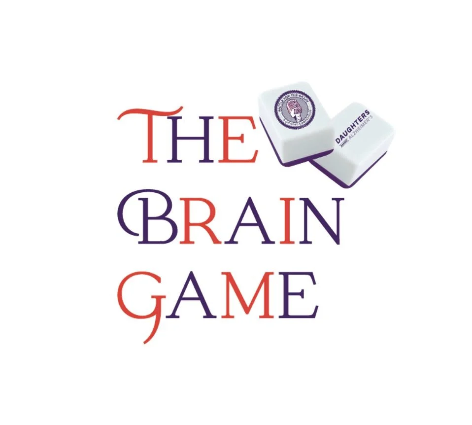 Logo for 'The Brain Game' with stacked text in red and purple, and two white Mahjong game pieces with purple logos and text.