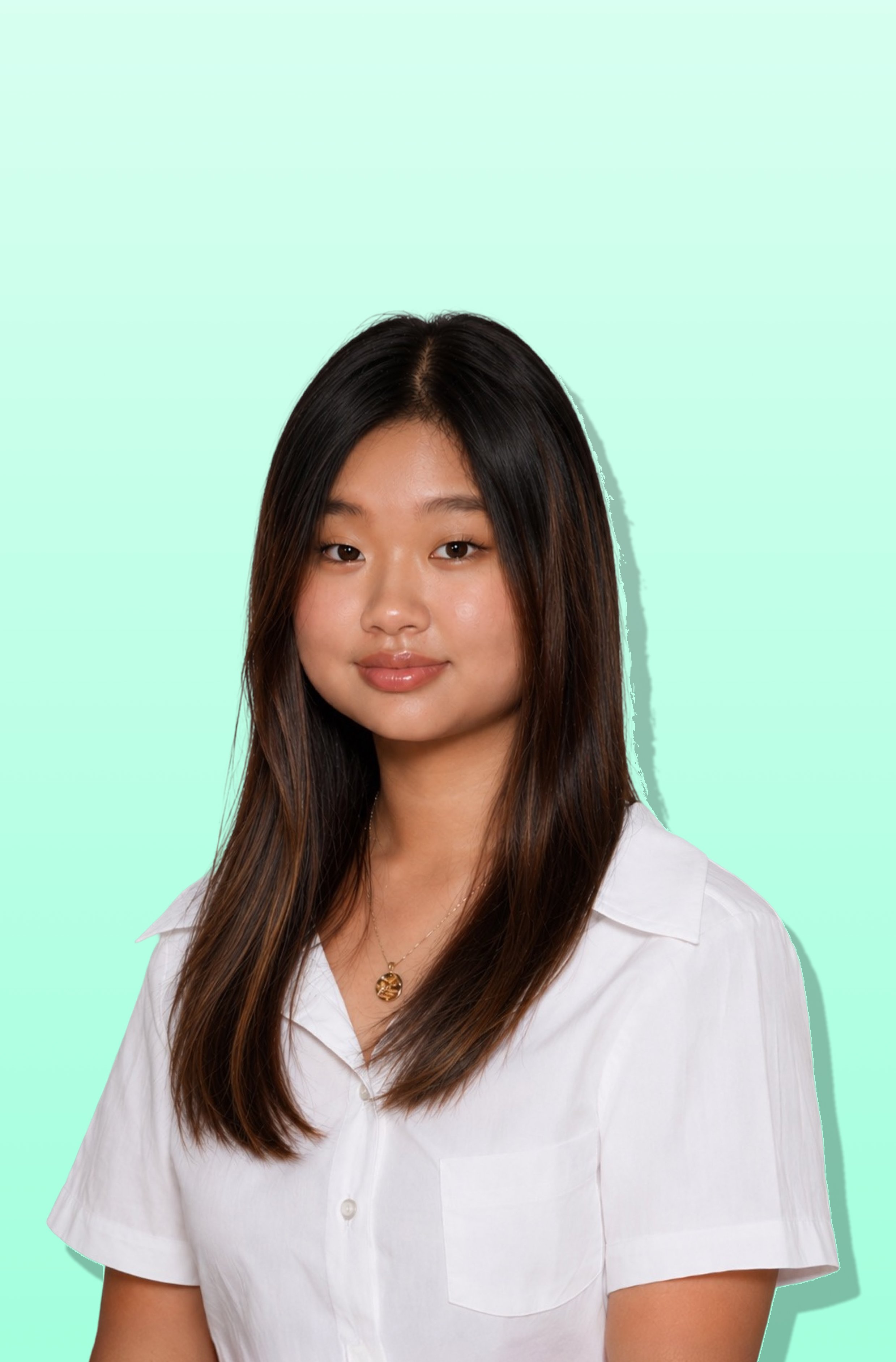 A young woman with long dark hair, wearing a white button-up shirt and a gold necklace, standing against a light mint green background.