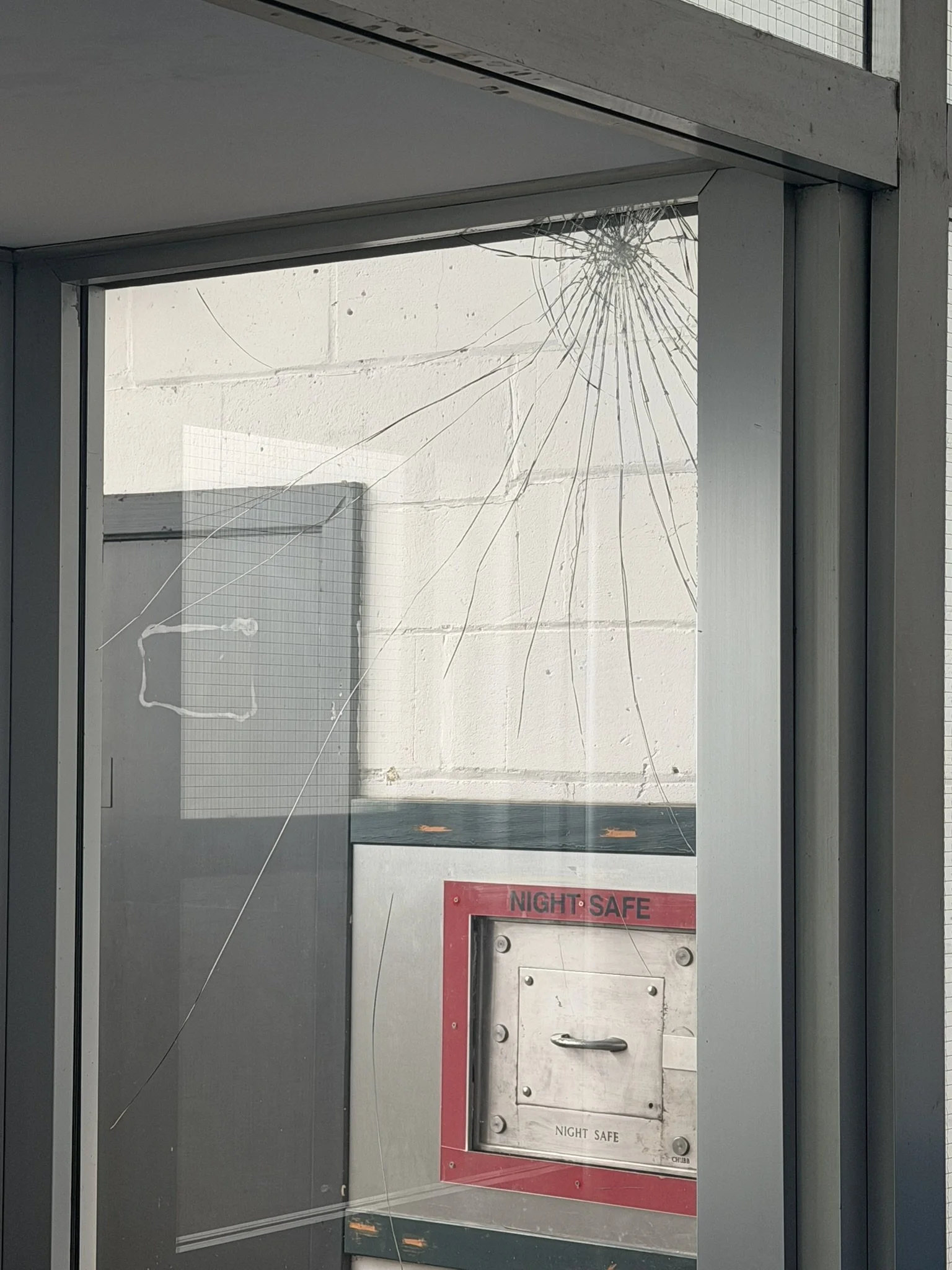 Smashed glass door - a safe for the former Clydesdale Bank can be seen.