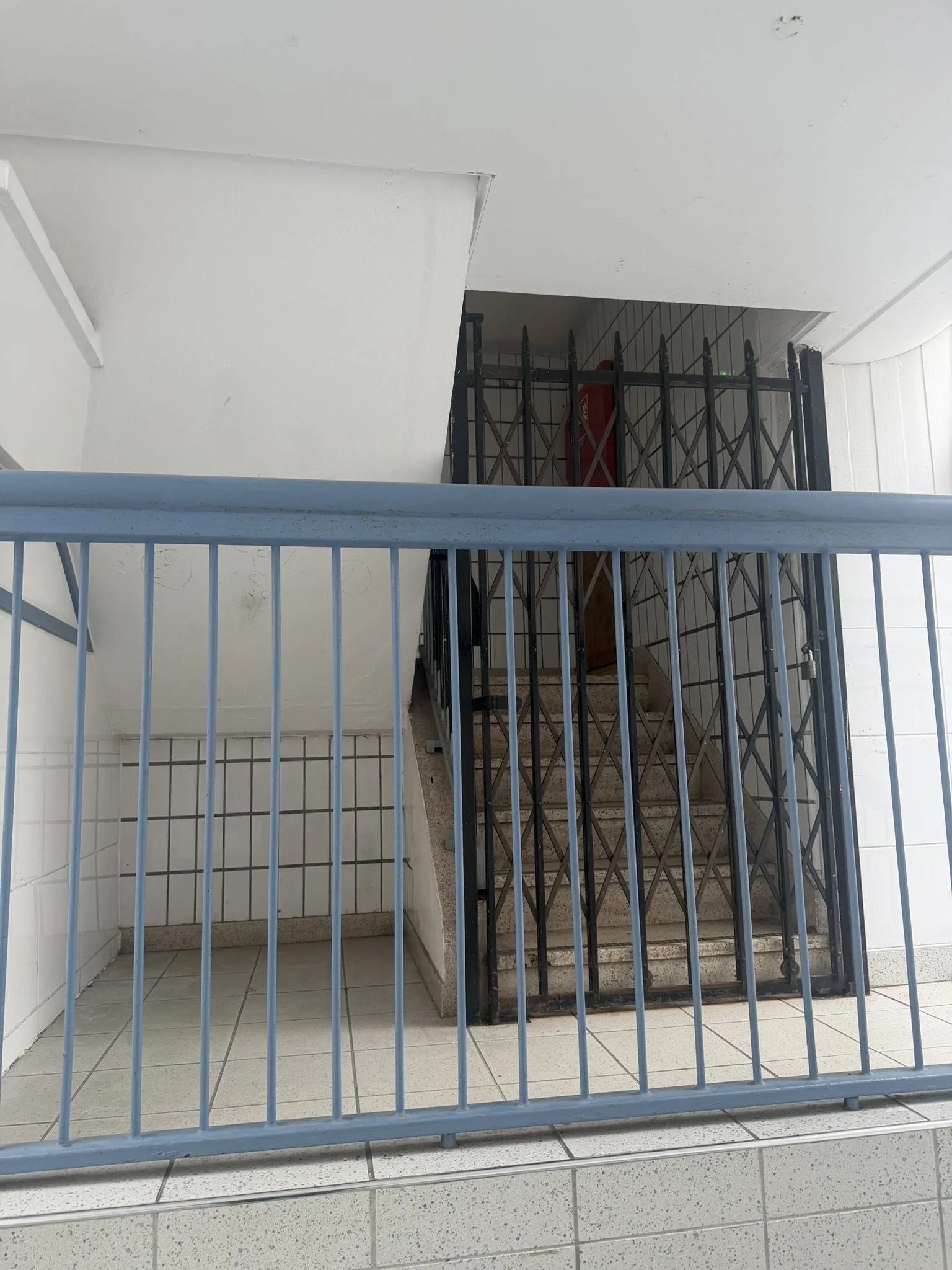 Now shuttered entrance to upstairs charity shop