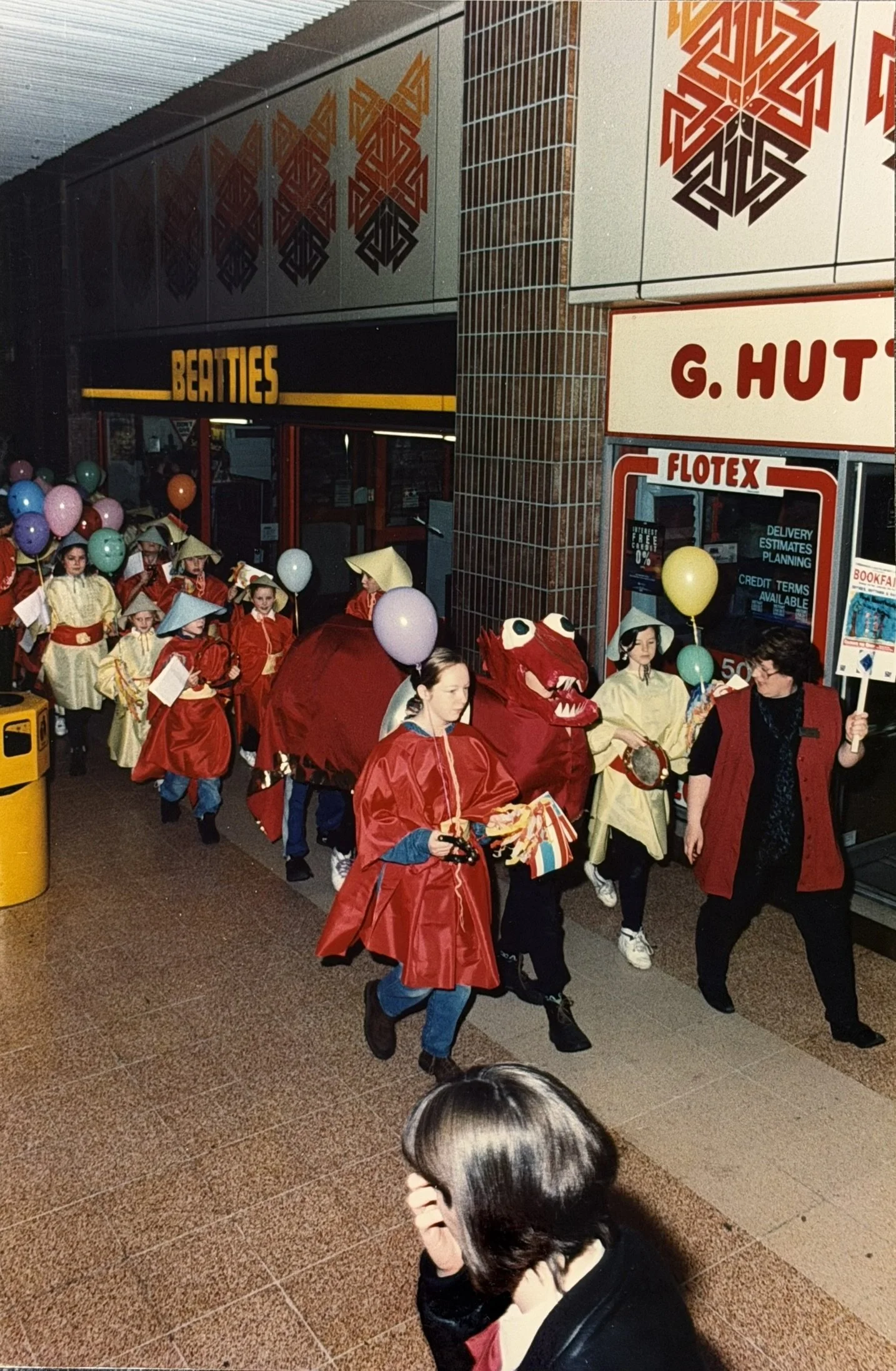 Chinese New Year library parade through Phase 1 shopping mall; Beatties and G. Hutt can be seen. Taken from Cumbernauld Library's own photo collection