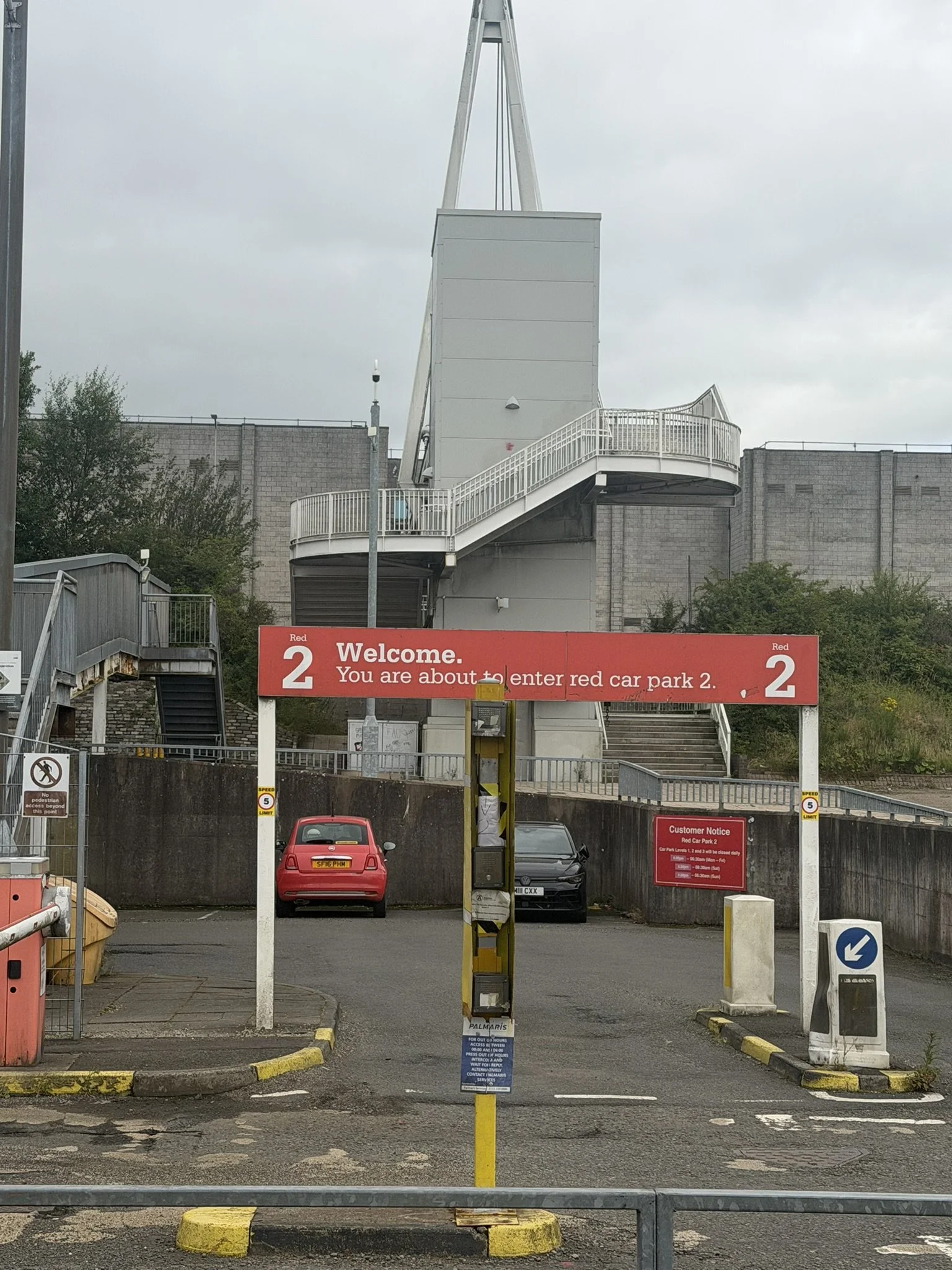 Entrance to town centre car park, with stairs to footbridge in the centre