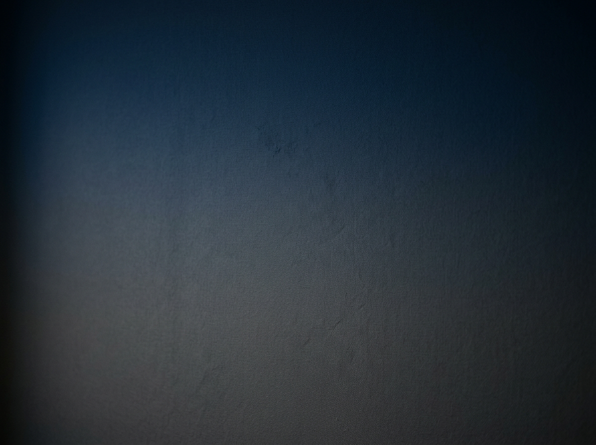 Close-up of a textured dark-colored surface, possibly a matte black or dark gray object.
