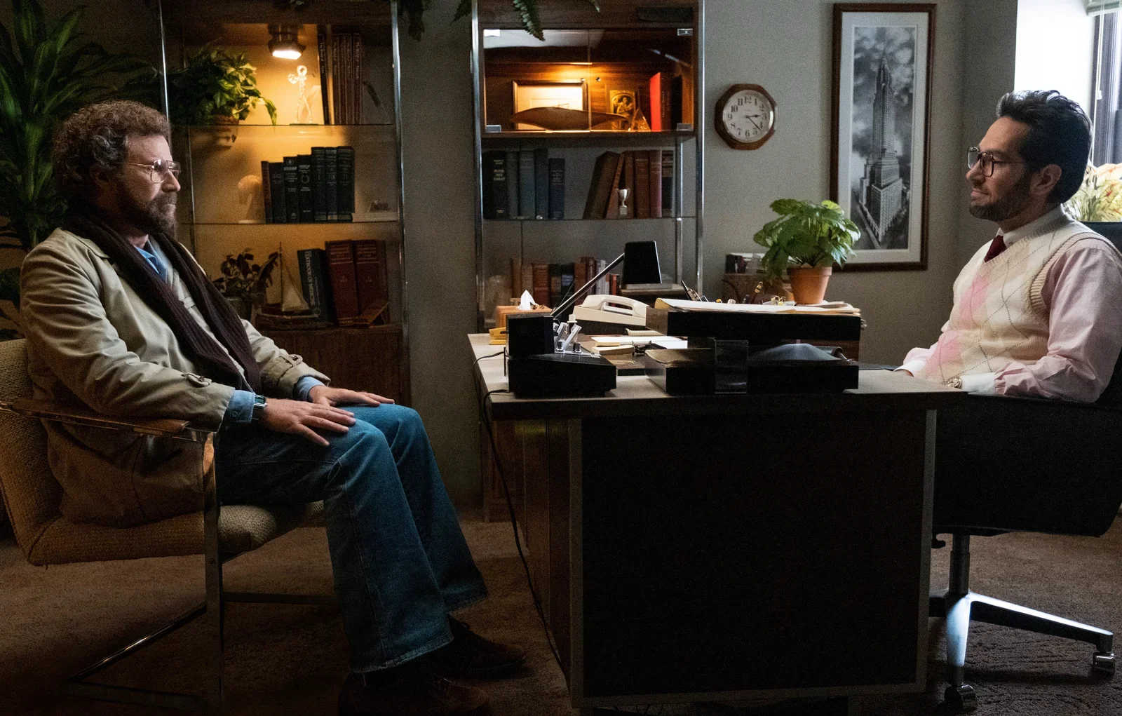 Will Ferrell sitting in an armchair across a cluttered desk from therapist Paul Rudd.