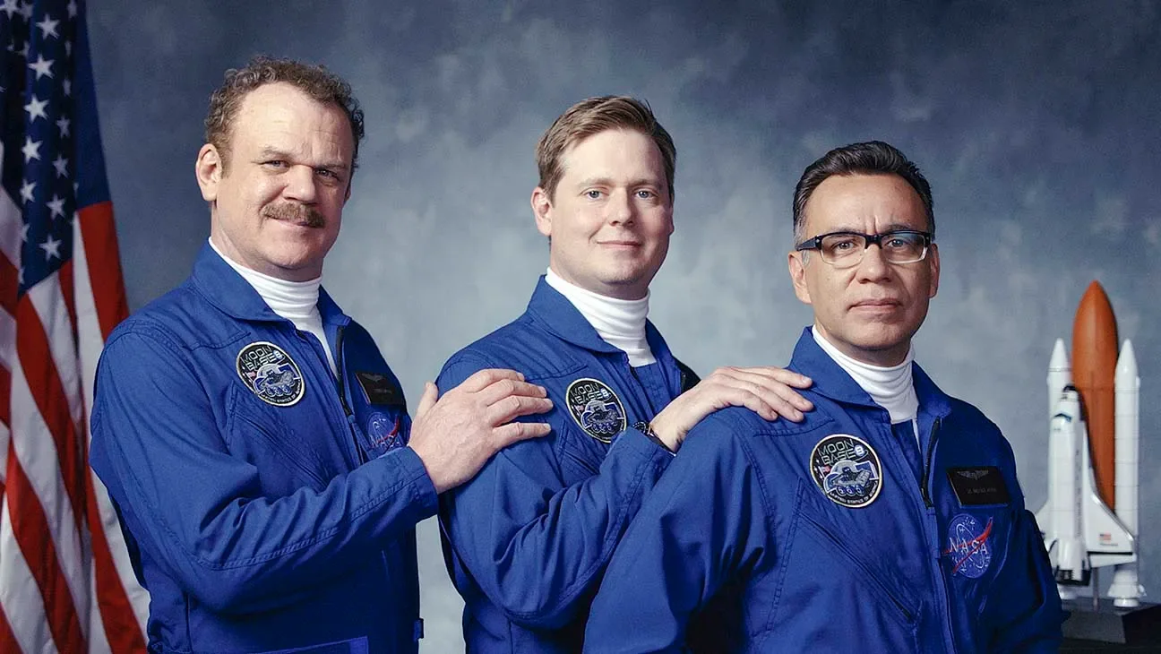 ohn C. Reilly, Tim Heidecker, and Fred Armisen posing in blue flight suits for a formal crew portrait in Moonbase 8.