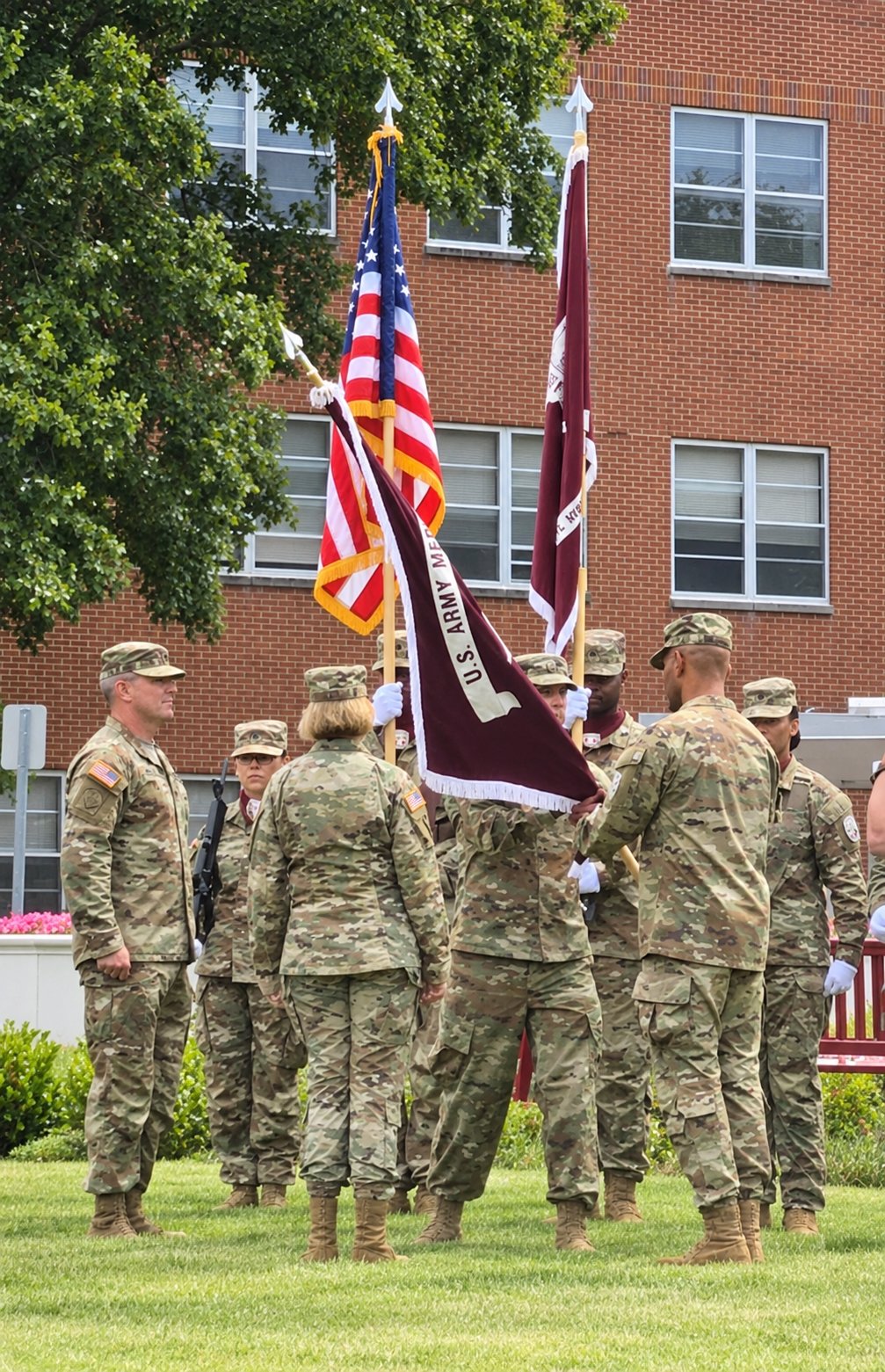 Military leaders pass the flag during a U.S. Army change of command ceremony.