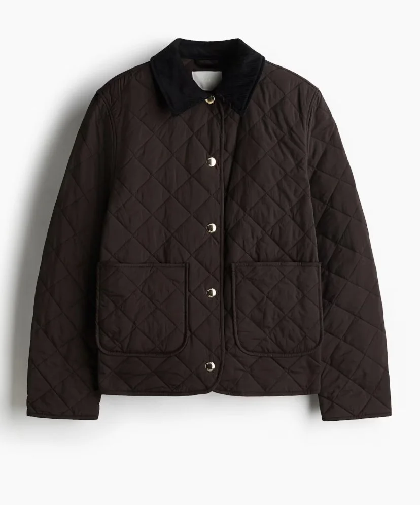 Brown quilted jacket with black collar and front pockets, buttoned up, hanging against a white background.