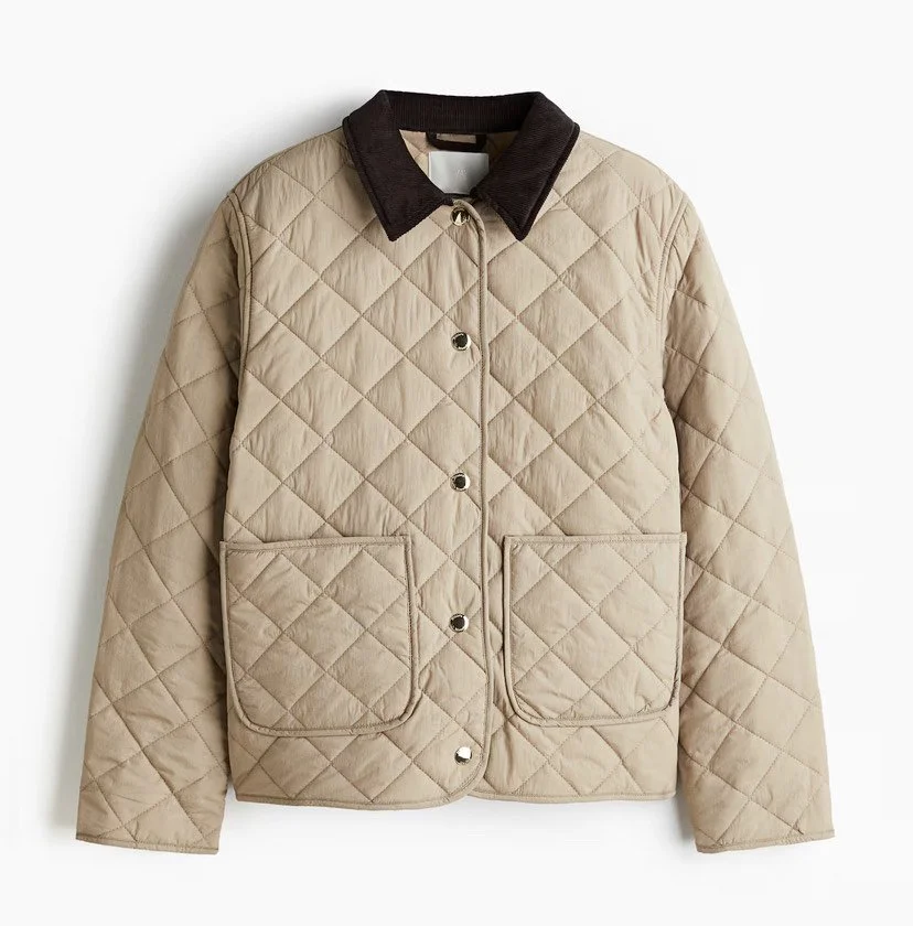 Beige quilted jacket with large front pockets and a dark collar.