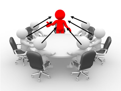 Red figure at head of conference table with six gray figures and black chairs, illustrating leadership or presentation.