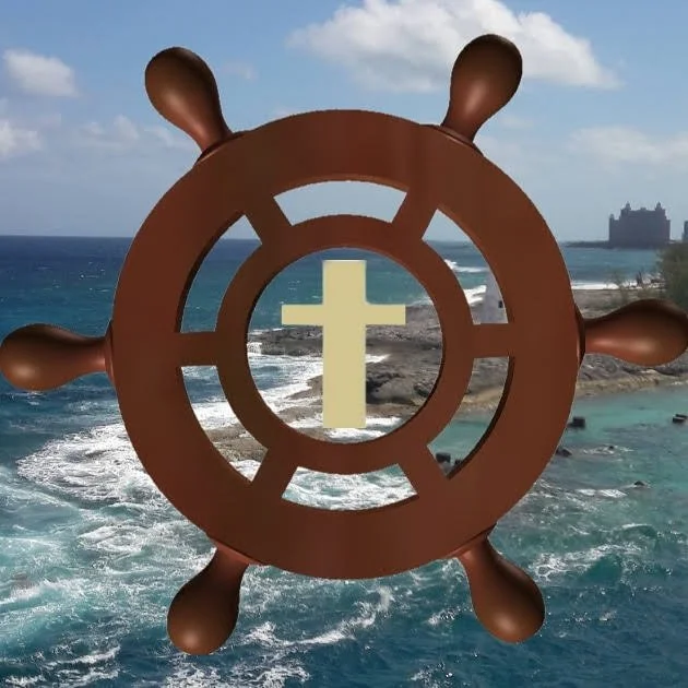 A ship's wheel with a cross in the center, superimposed over a coastal scene with ocean waves, rocks, and a distant building.