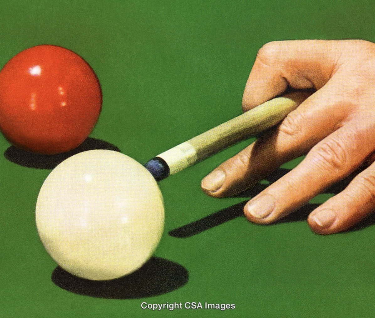 A hand using a cue stick to aim at a yellow billiard ball on a green pool table, with a red billiard ball nearby.