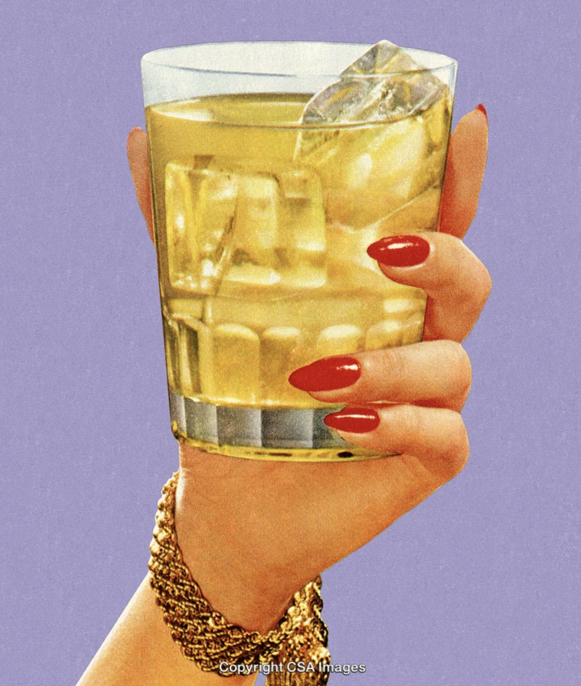A hand with red-painted nails holding a glass filled with a yellowish beverage and ice cubes, set against a purple background.