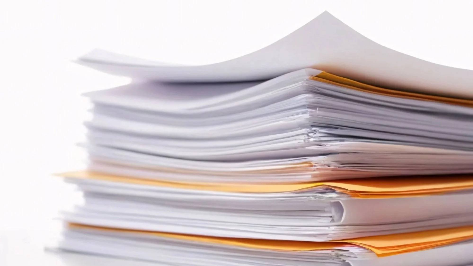 Stack of disorganized papers with white, yellow, and light purple sheets, some crumpled or bent.
