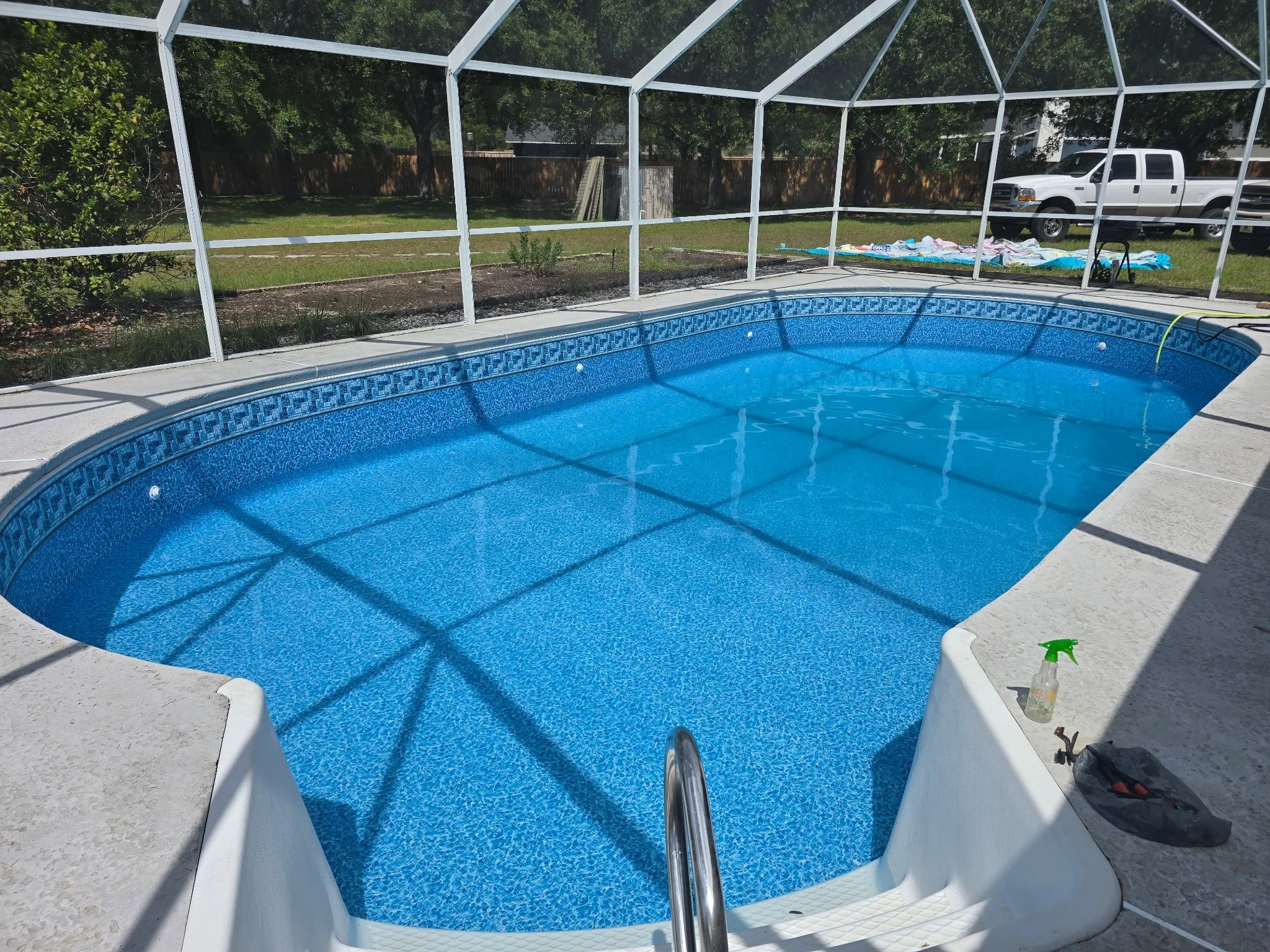 Inground swimming pool liner replacement inside screened enclosure.