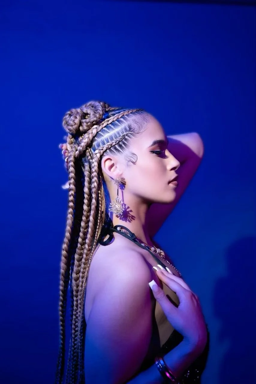 Long braided hairstyle with braided buns at Salon de Weave