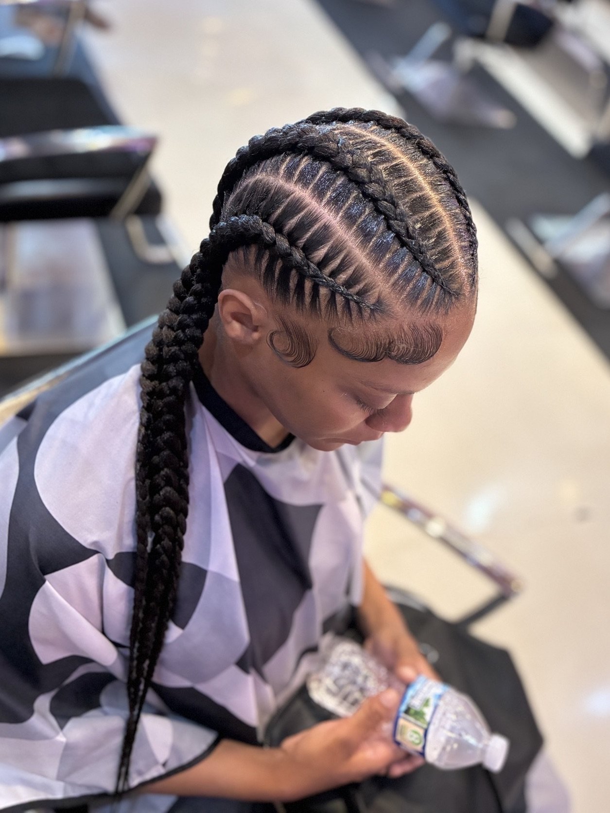 Cornrow braids styled into long braids at Salon de Weave