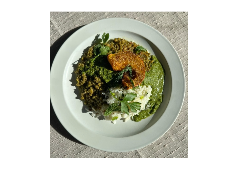 Green mung dal with Jeera Rice and Spring Herb Chutney on a white plate