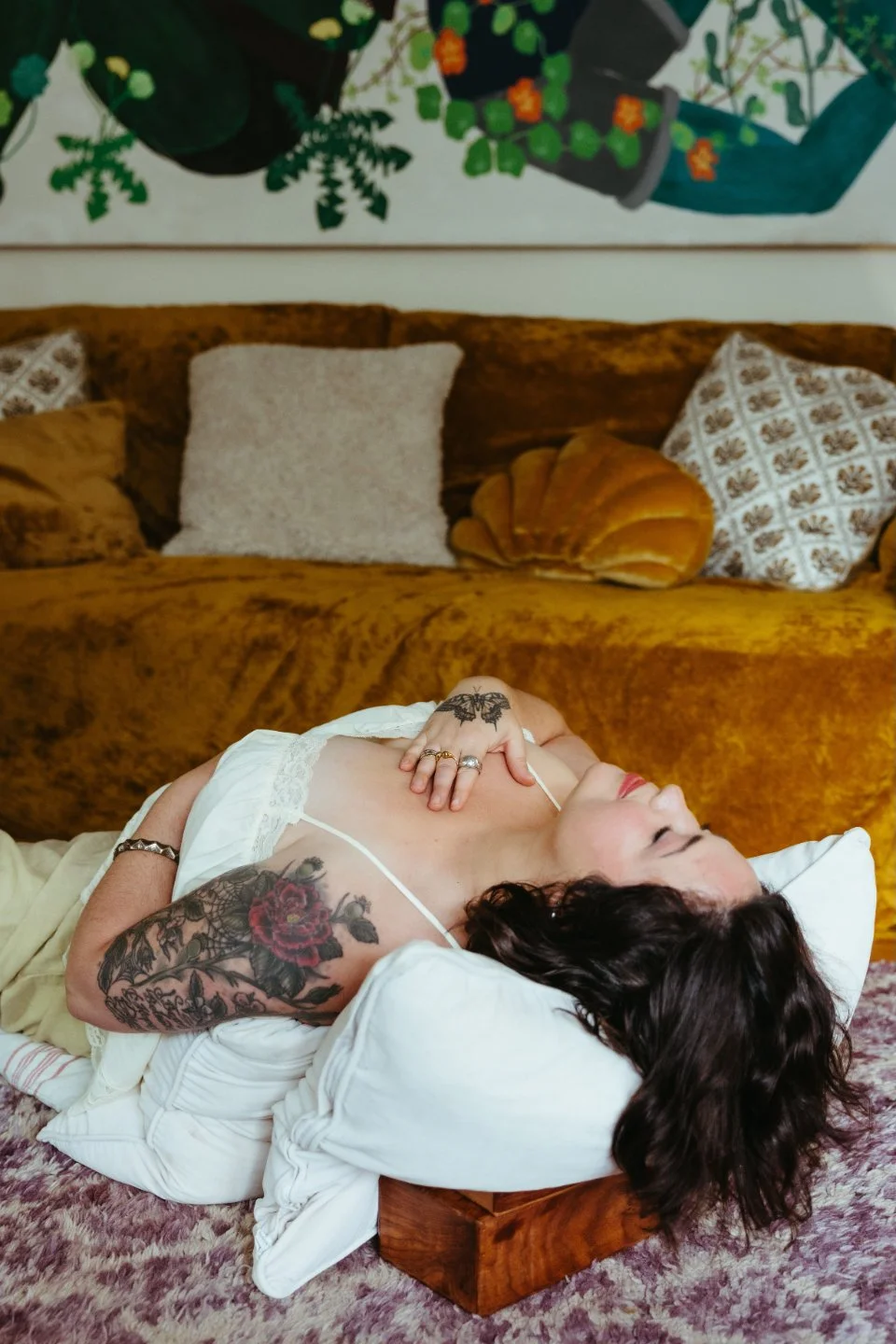 Woman lying on her back with eyes closed, hand on chest